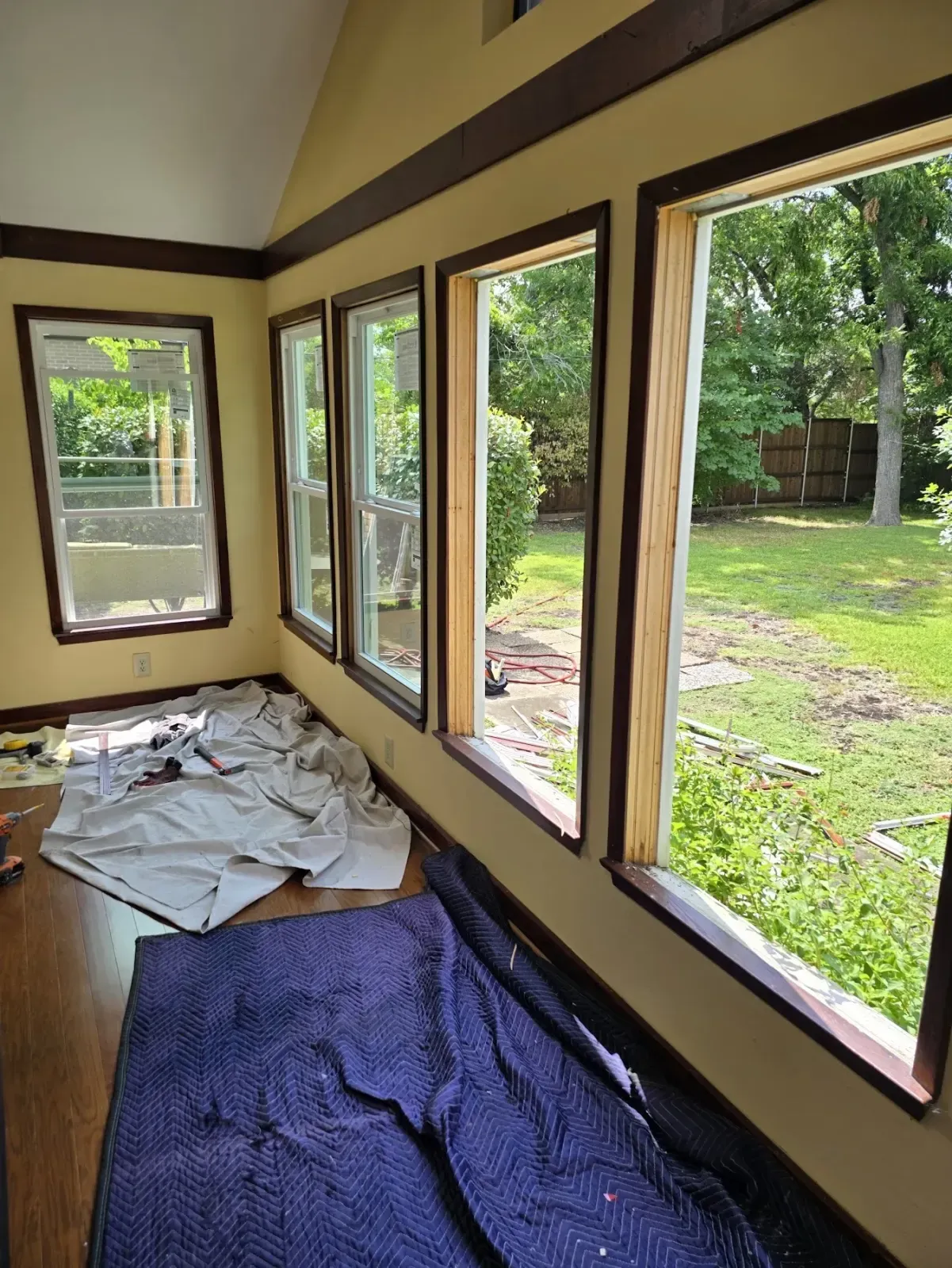 Vistamark window replacement in progress in a Historic Downtown McKinney sunroom with original trim protected
