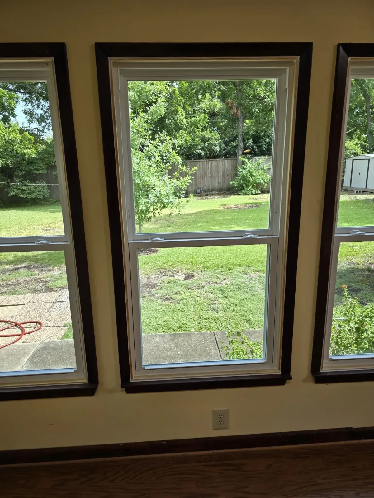 Three new white Vistamark double-hung windows overlooking the backyard in Historic Downtown McKinney