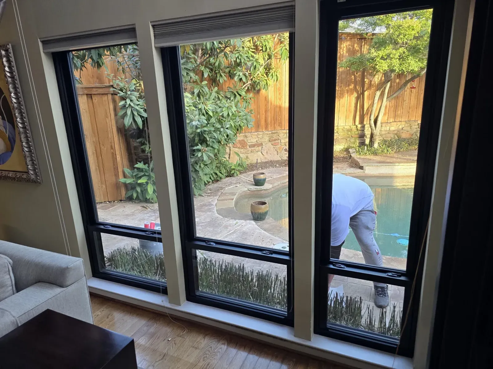 Three new bronze ProVia Endura windows overlooking the pool in a Stonebridge Ranch home