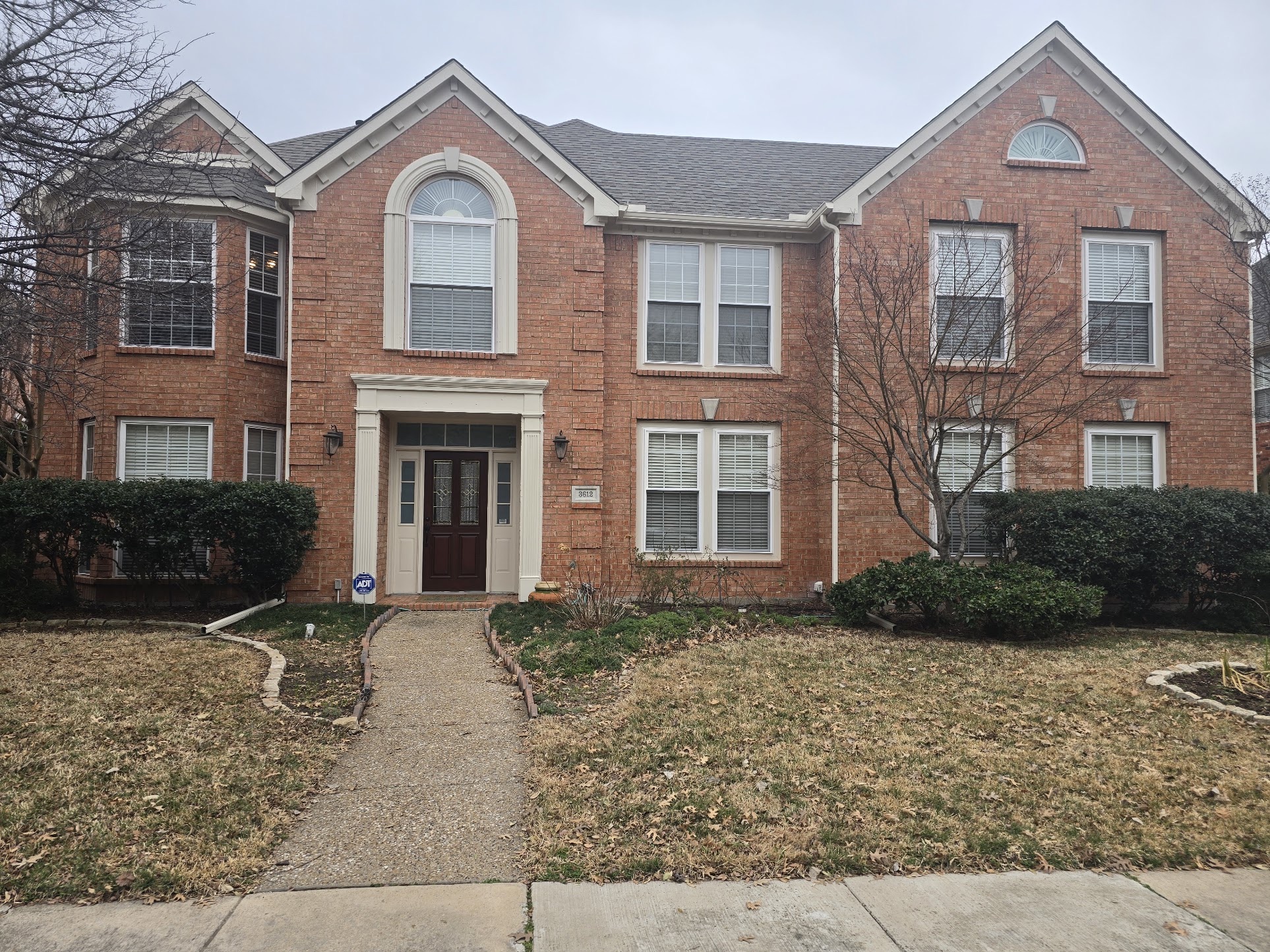 Two-story brick Plano home prepared for full ProVia window replacement